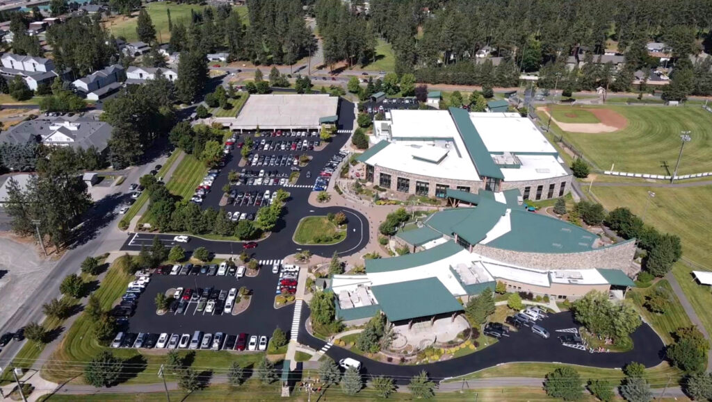 Aerial view of the KROC Center parking lot after asphalt patching, sealcoating and striping in Coeur d'Alene, Idaho.